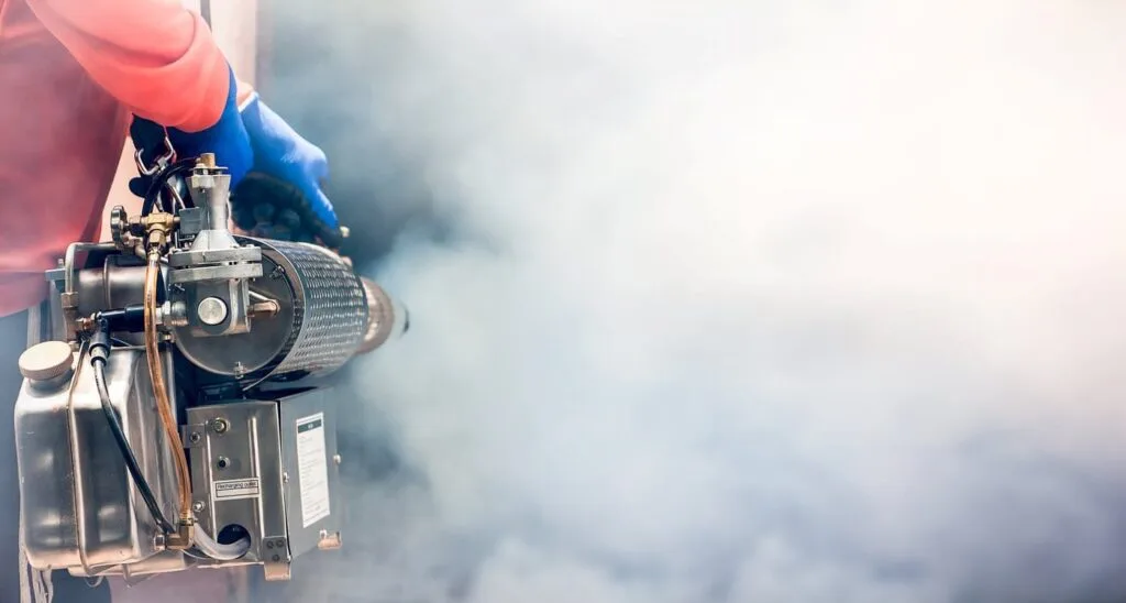 A worker uses a fumigation machine.