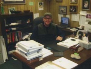 Phillip Clegg at a desk.