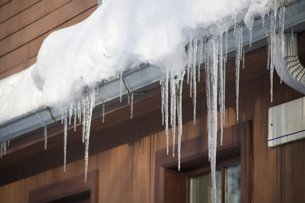Icicles forming around the gutters of a house